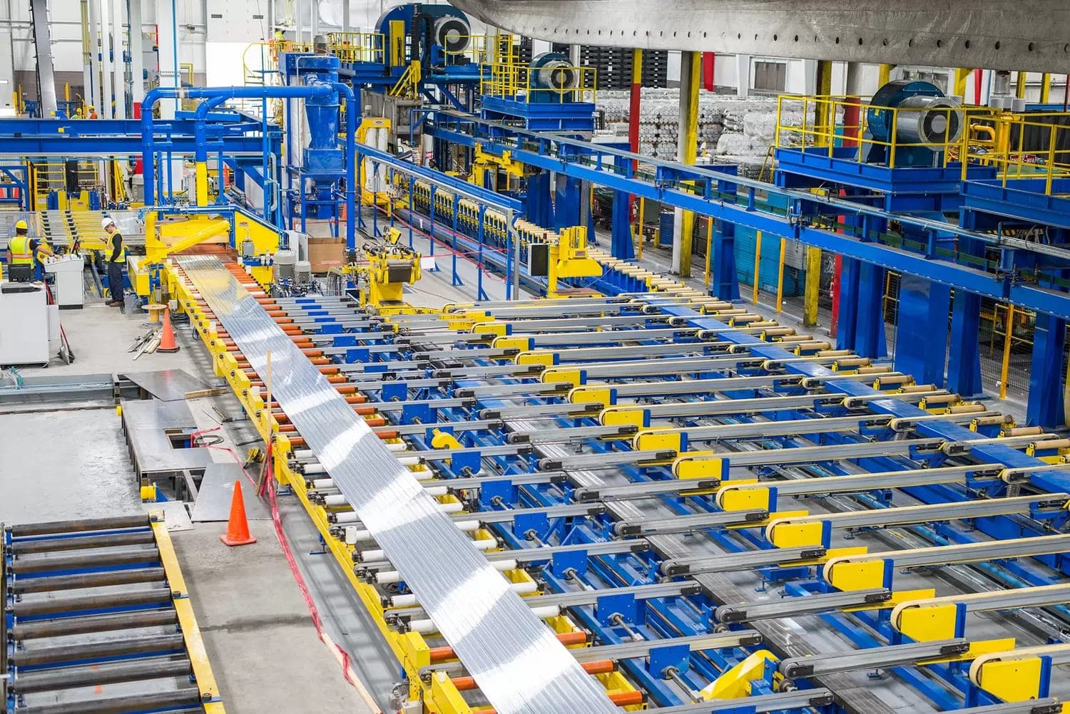 Aluminium extrusion line — freshly extruded profiles on the run-out conveyor